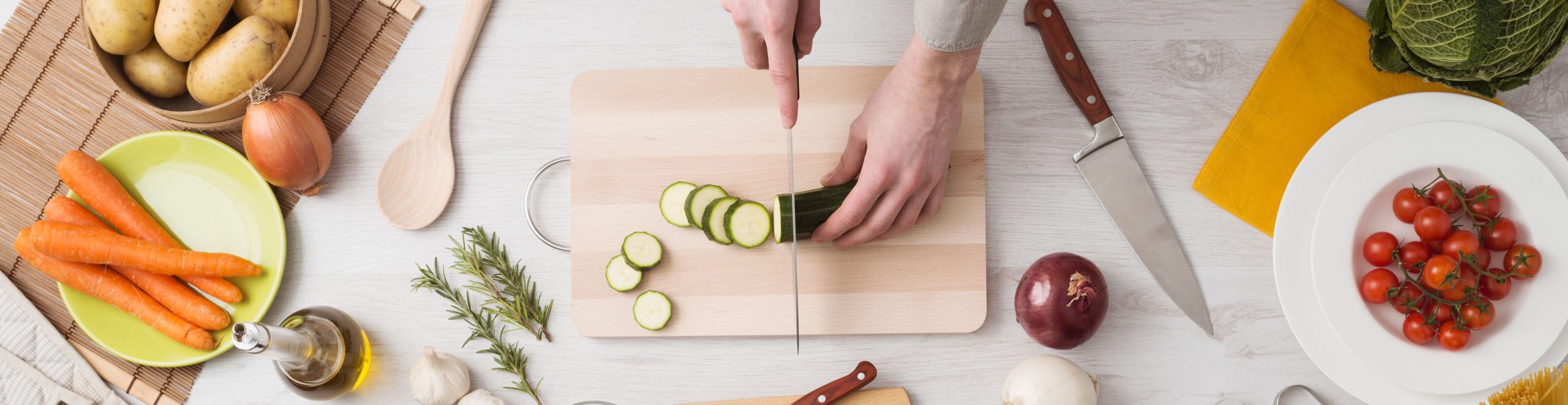 A woman cutting a cucumber