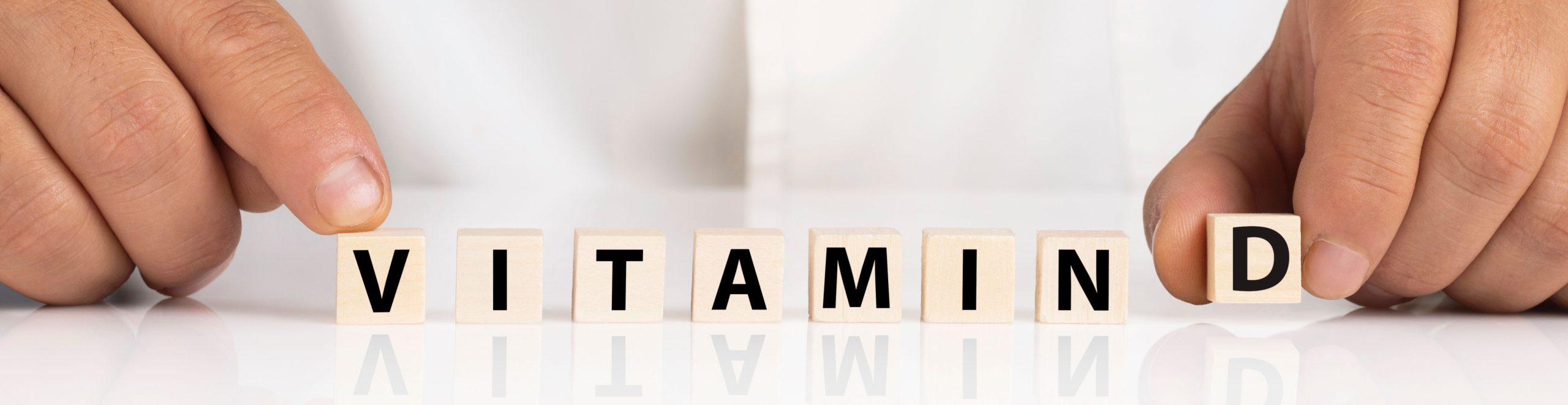 A doctor holding scrabble letter spelling vitamin D