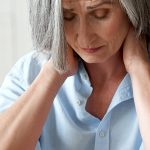 A middle aged woman, in front of her laptop